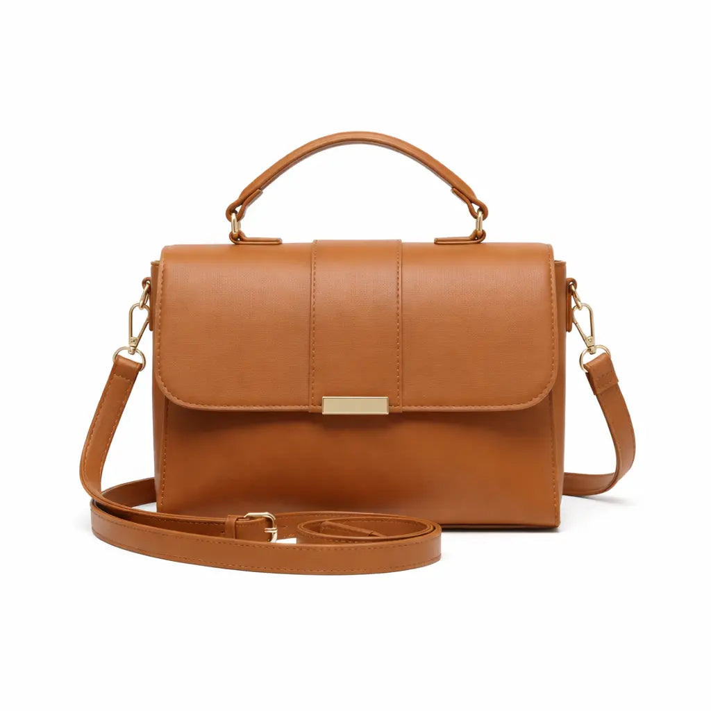Tan leather handbag with gold hardware and adjustable shoulder strap, front view on white background