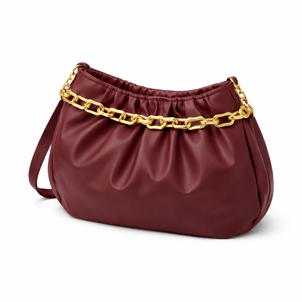 Burgundy ruched shoulder bag with gold chain detail and leather strap on white background