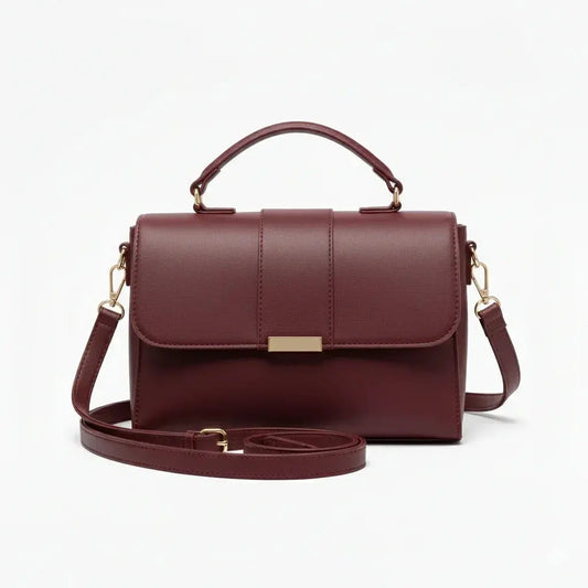 Elegant skin-tone top handle purse with smooth leather finish and adjustable shoulder strap