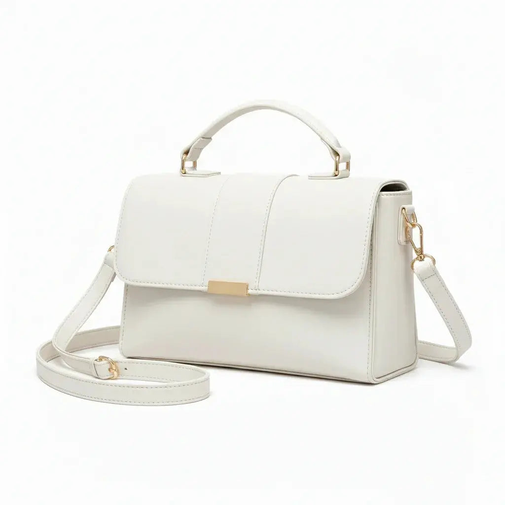 Elegant white leather handbag with top handle, gold-tone hardware, and detachable strap